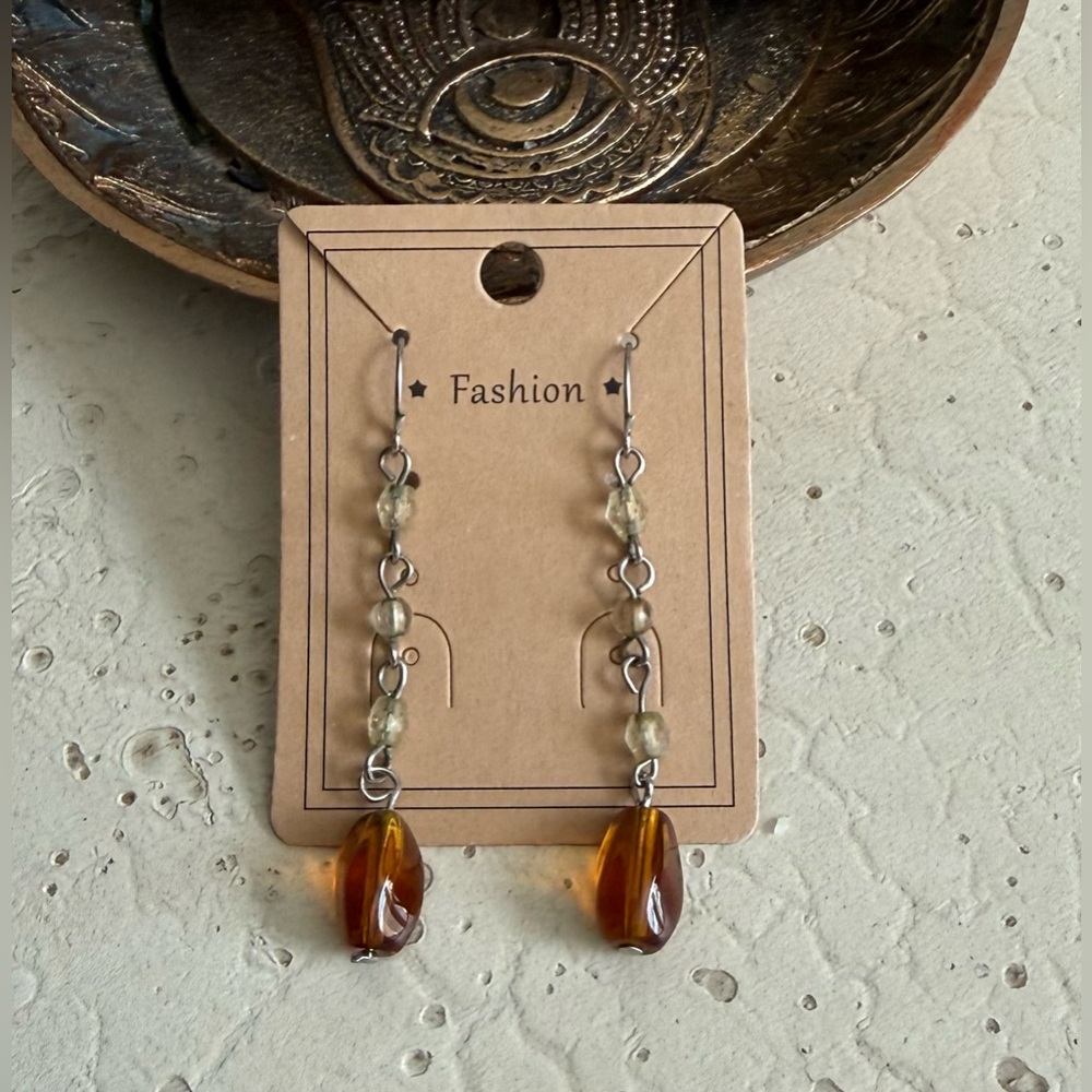 Dangle brown bead earrings. Rubber earring backs. New in packaging.